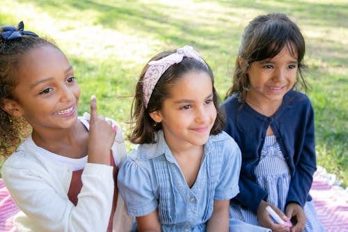 Free Pretty Smiling Girls Sitting Together Stock Photo