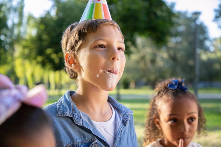 Close Up Photo Of Boy Eating Whipped Cream