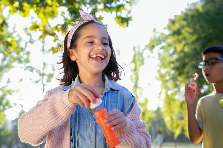 Kids Holding Bubble Blowing Toys