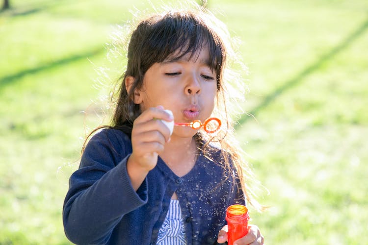 Girl Blowing Bubble Toy 