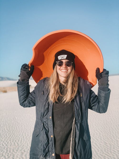 Free Woman with Sandboard in Desert Stock Photo