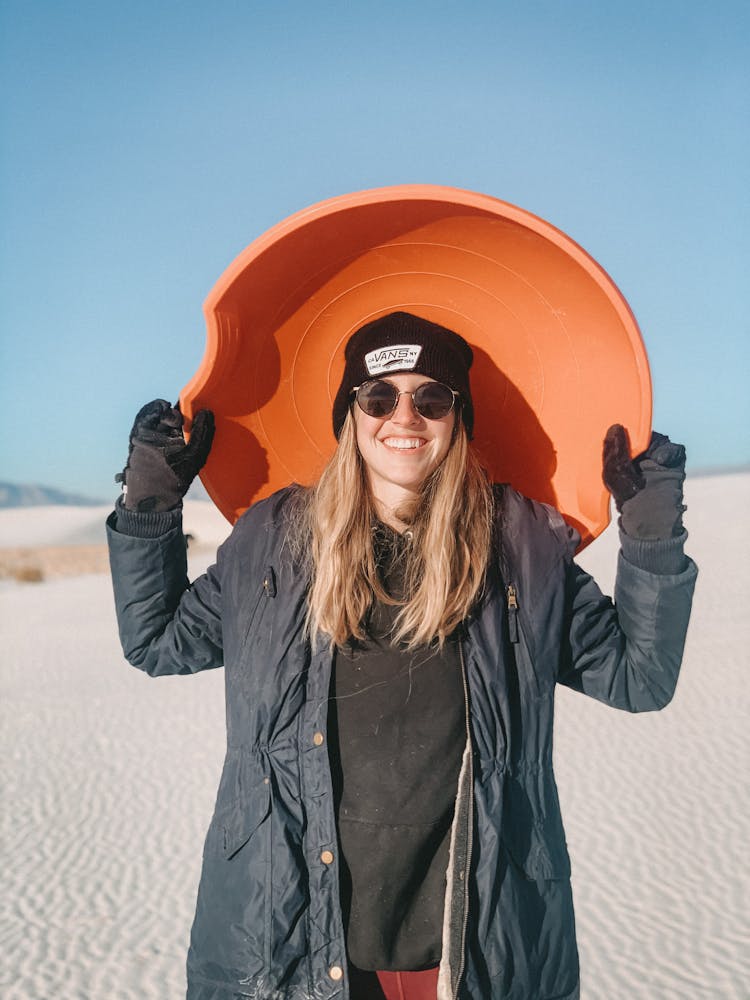 Woman With Sandboard In Desert