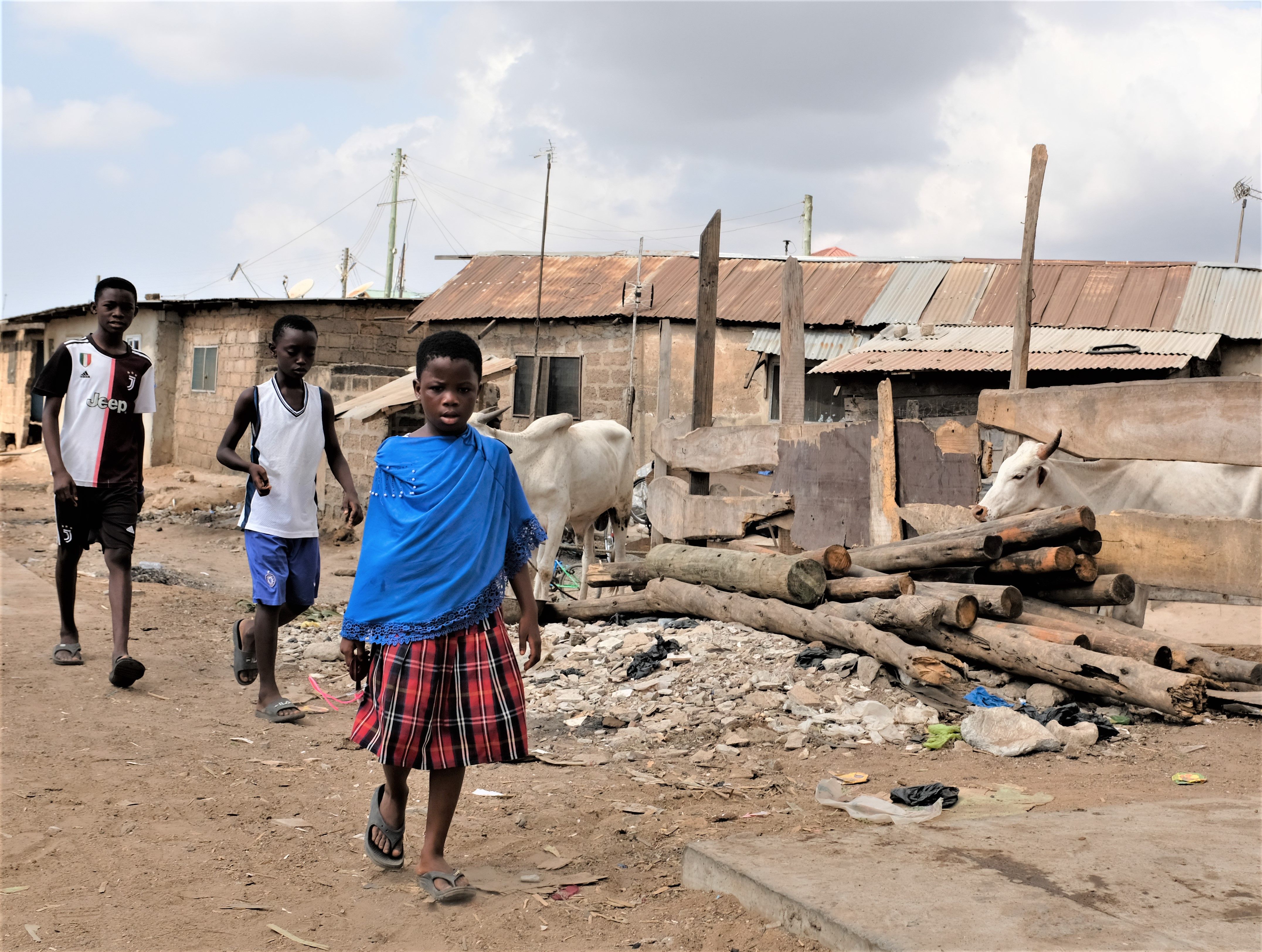 Group of children walking in a rustic neighborhood in Accra, Ghana.