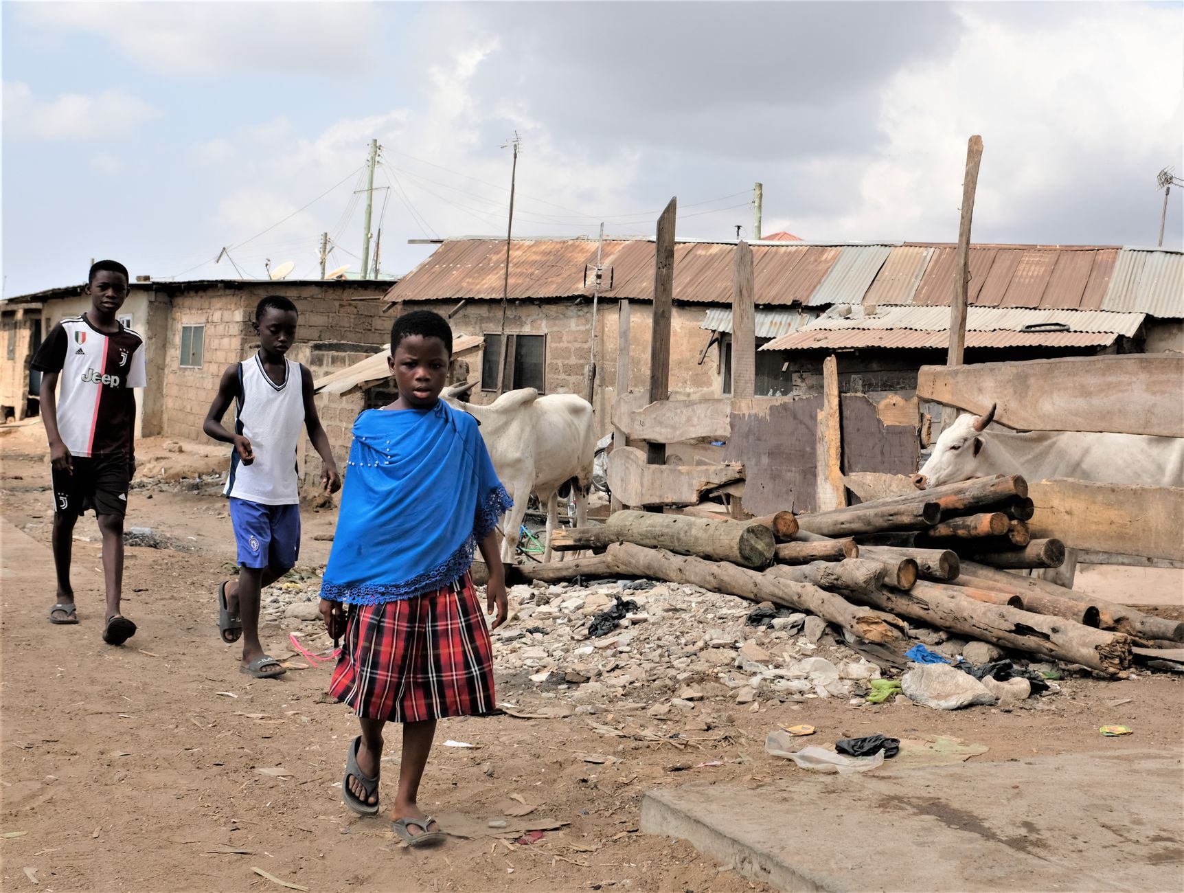 Group of children walking in a rustic neighborhood in Accra, Ghana.