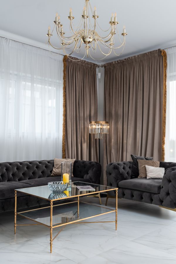 Cozy living room with sofas beside curtained windows