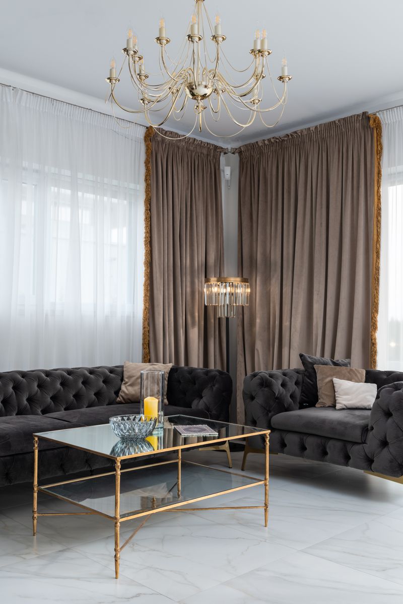 Cozy sitting area with sofas beside curtained windows
