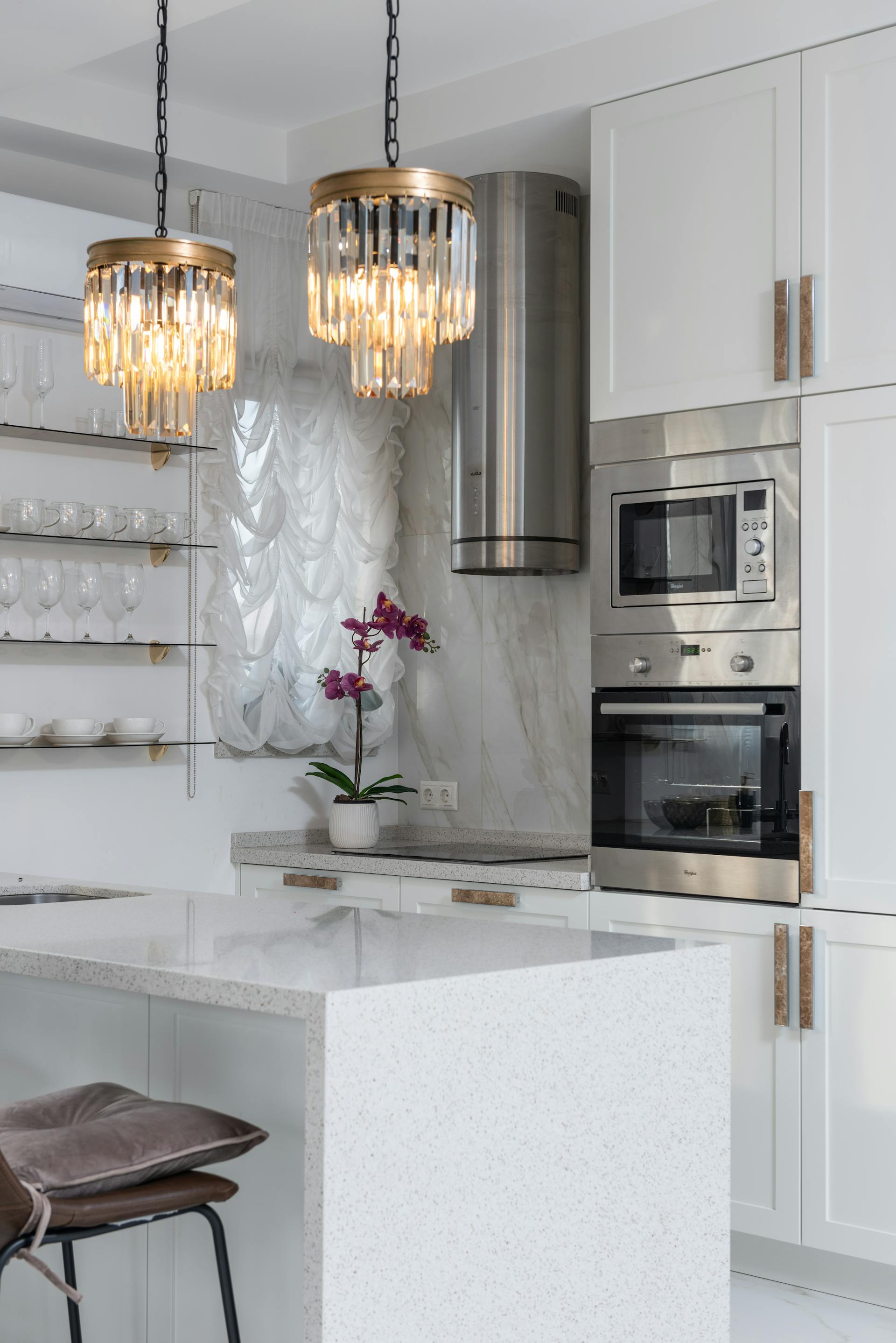 A bright modern kitchen with white cabinets and modern appliances