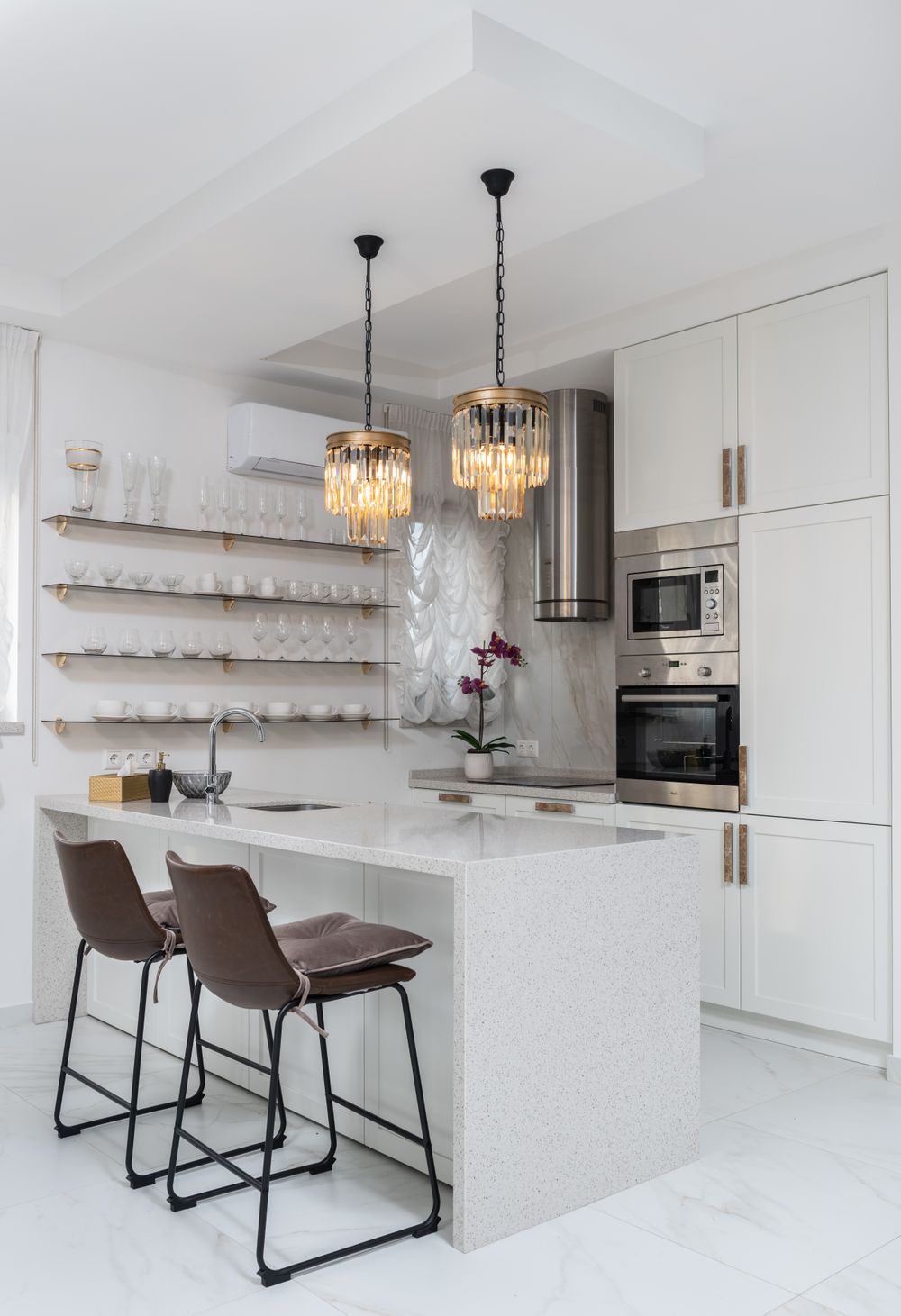 Detail of a sleek modern kitchen with custom cabinetry and pendant lighting