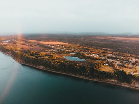 A breathtaking aerial view capturing a tranquil lake and countryside landscape, ideal for nature enthusiasts.