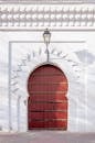 Arched door of white ornamental building in sunlight