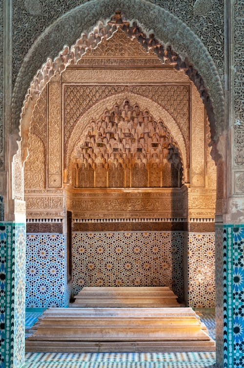 Free Ornamental Moorish styled archway with traditional decorative muqarnas and tiles inside of ancient Saadian Tombs located in Marrakesh Stock Photo