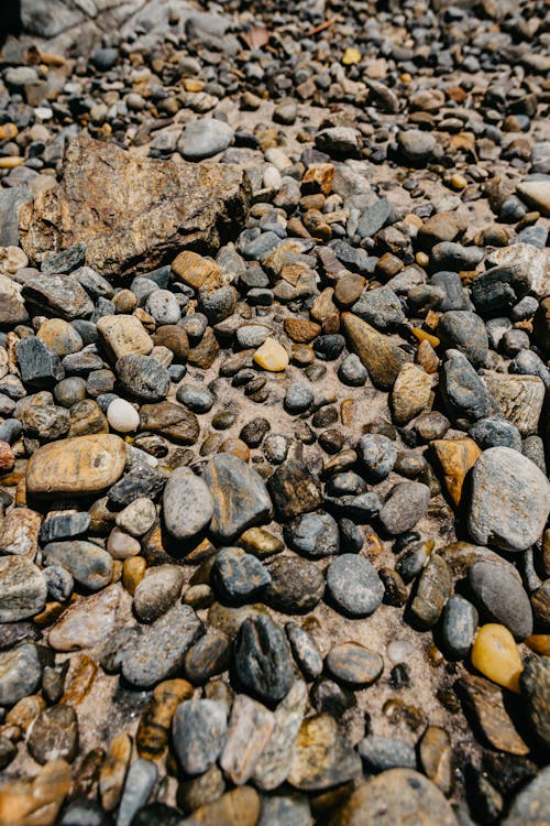Textured backdrop of stones on beach in daytime