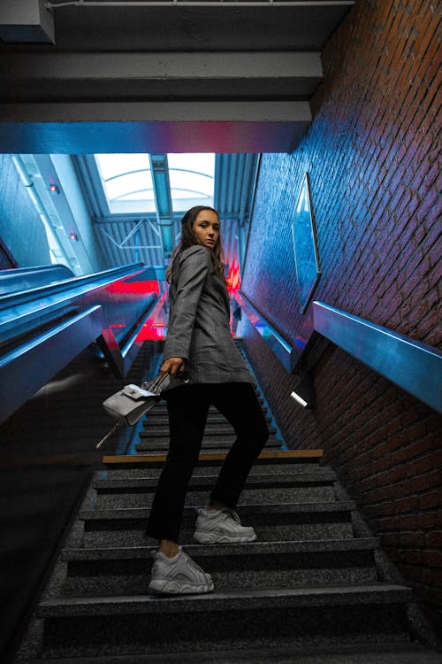 Free Stylish young lady walking upstairs in metro station Stock Photo