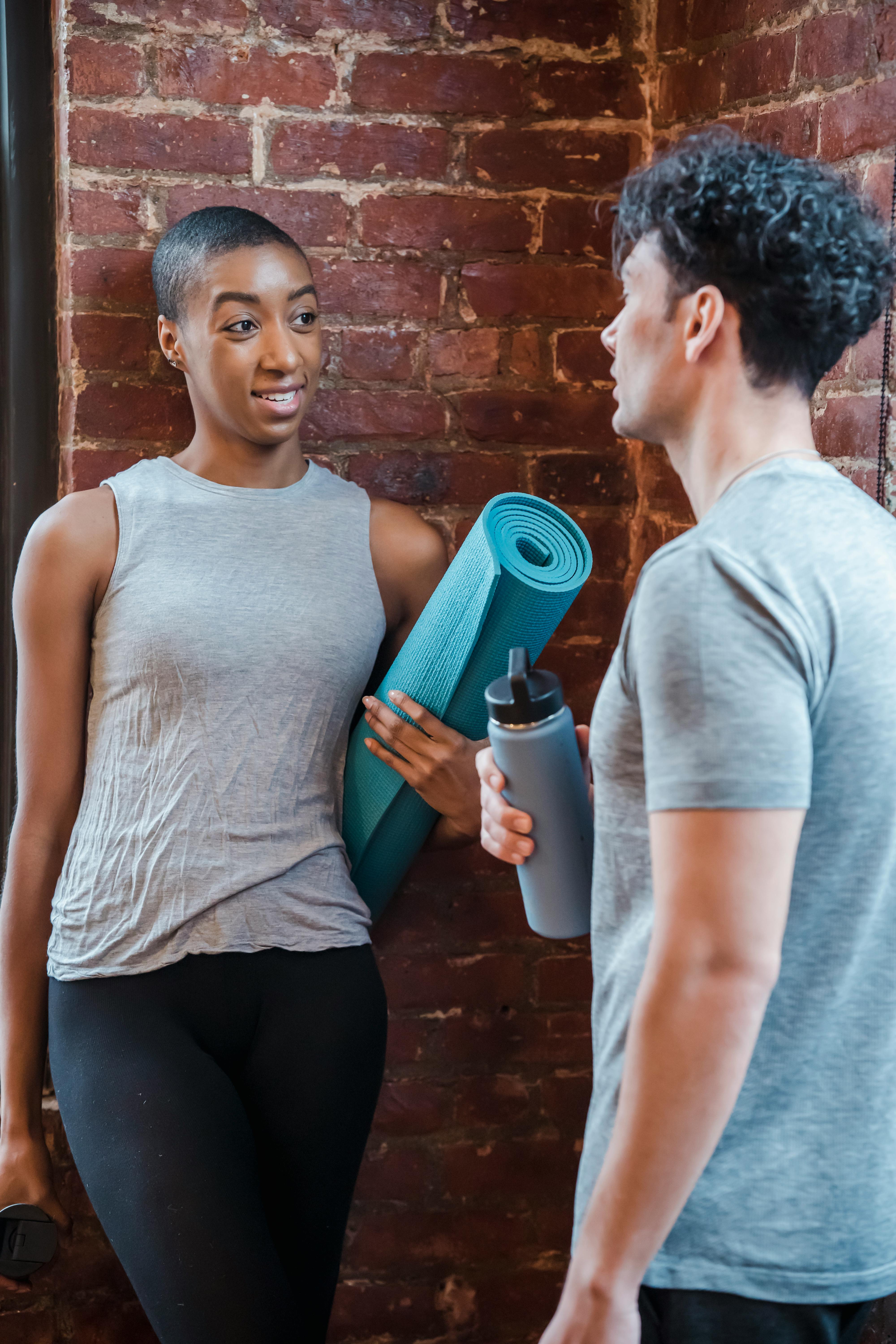 diverse couple in sportswear having conversation