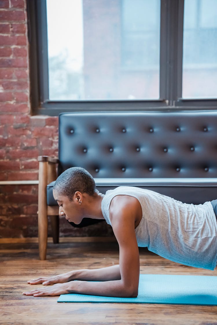 Serious Black Woman Doing Forearm Plank