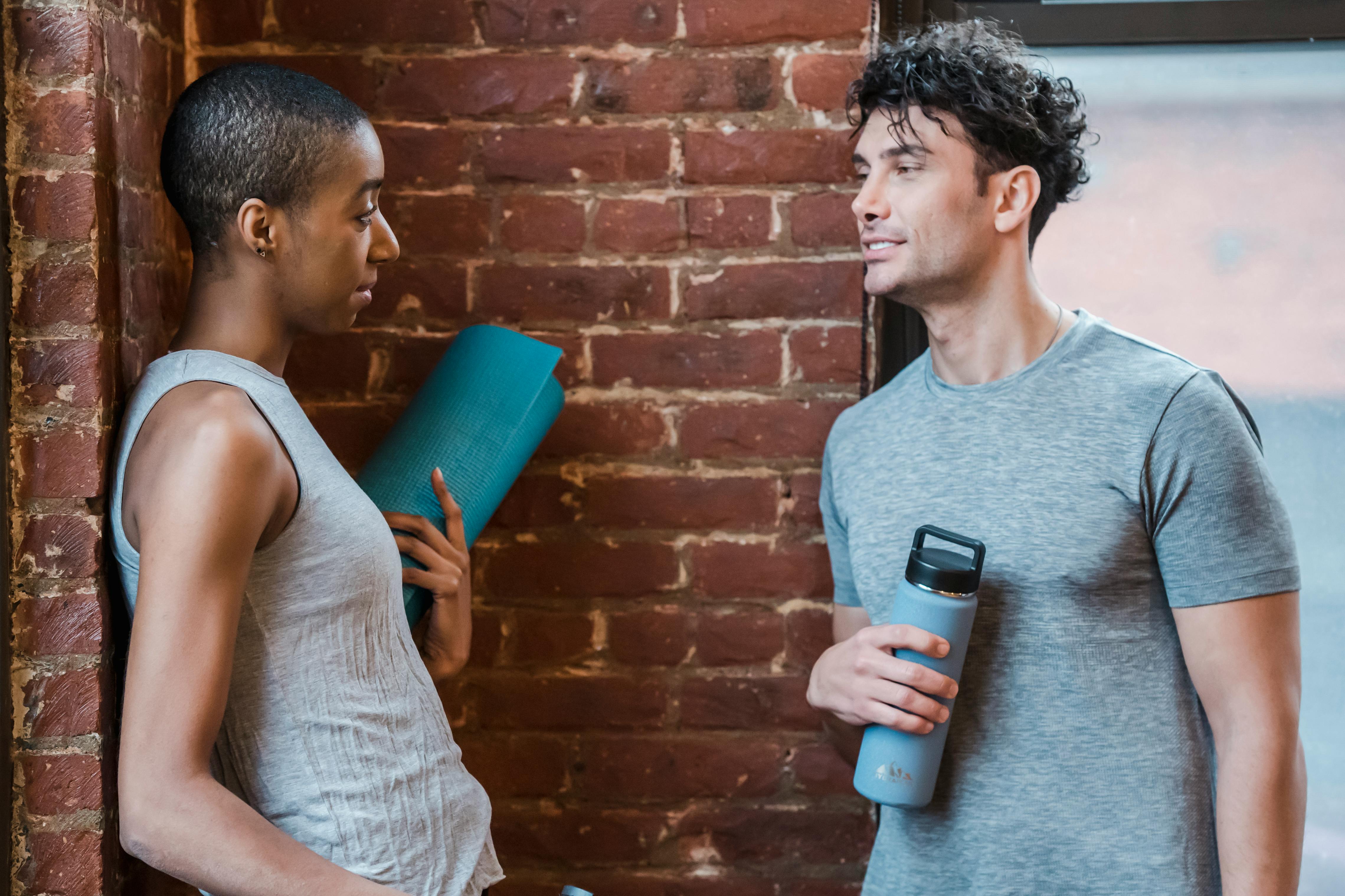 sportive diverse couple having conversation