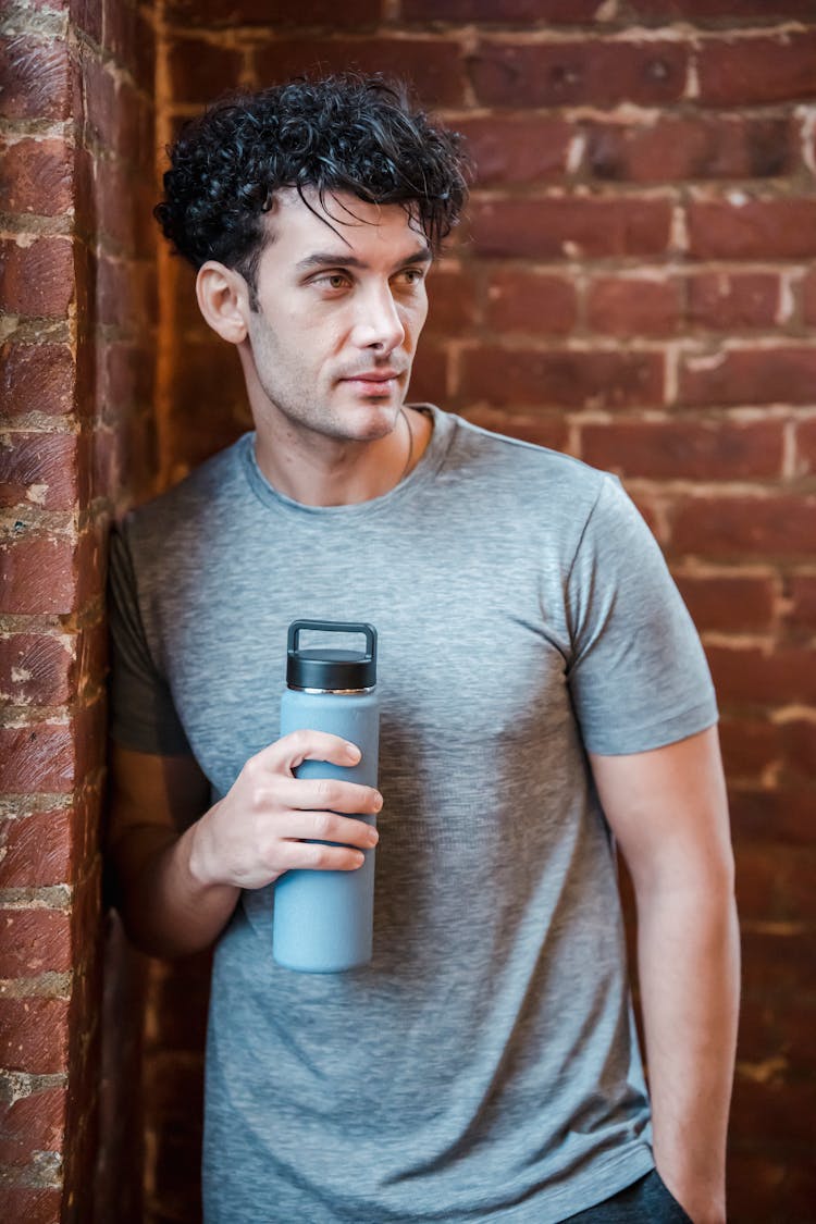 Sportive Man With Water In Gym