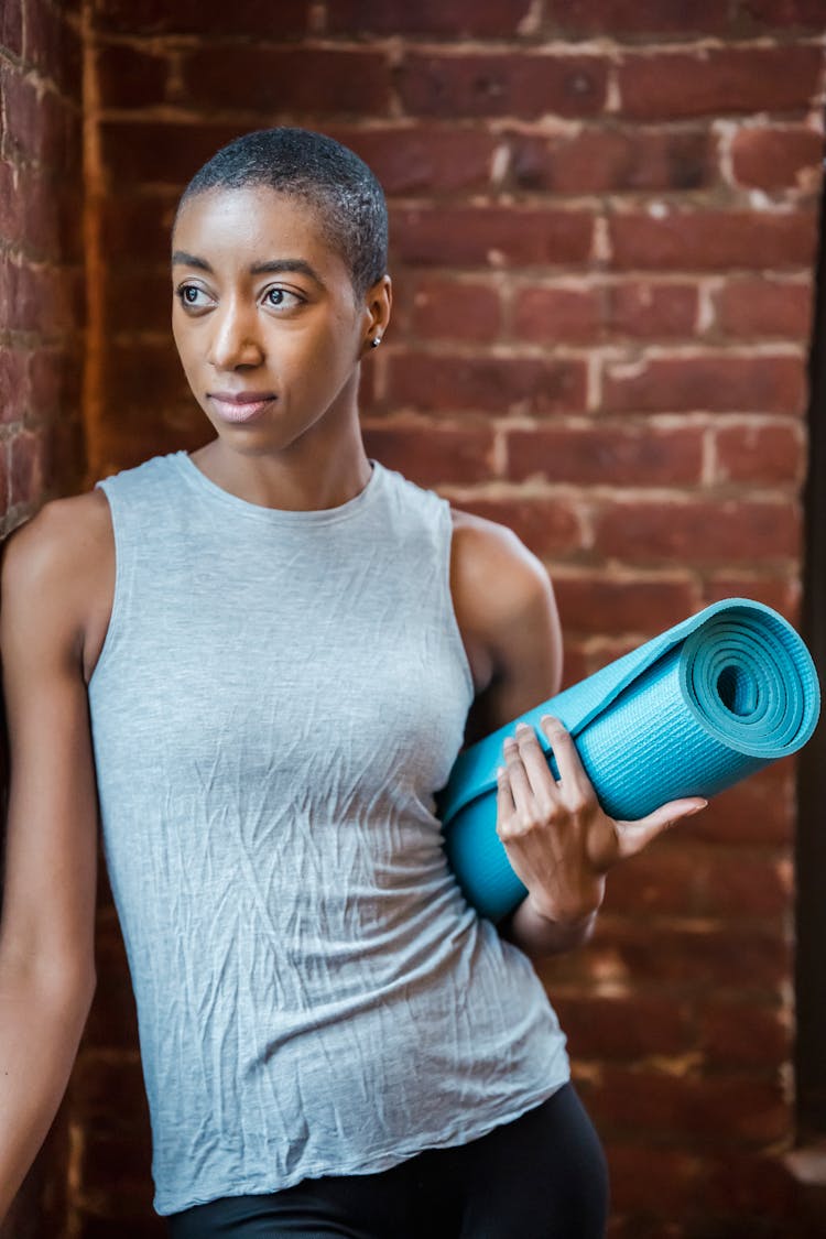 Black Sportswoman With Mat In Gym