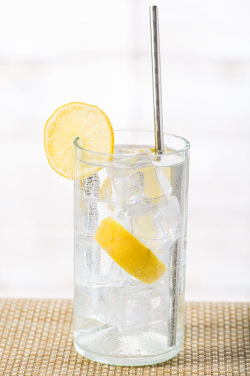 A Close-Up Shot of a Lemon Water with Ice in a Glass