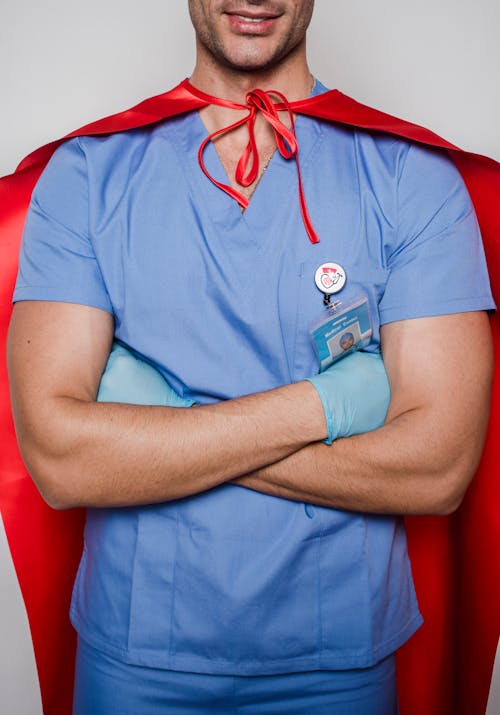 Smiling doctor in uniform and superhero costume