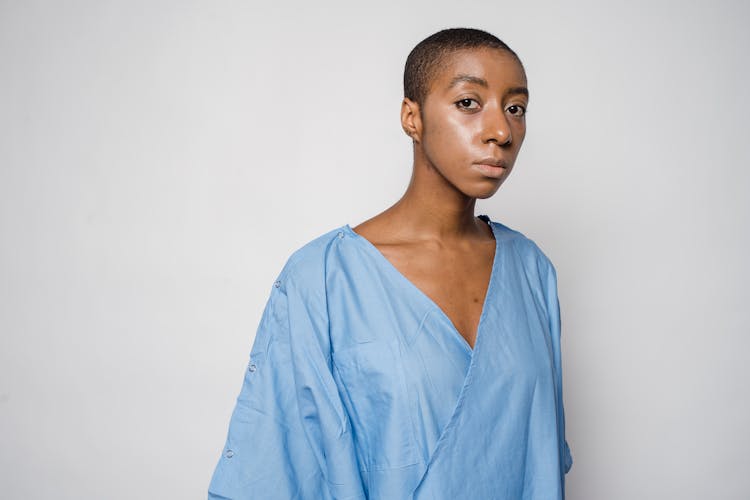 Upset Black Woman In Blue Medical Uniform In Clinic