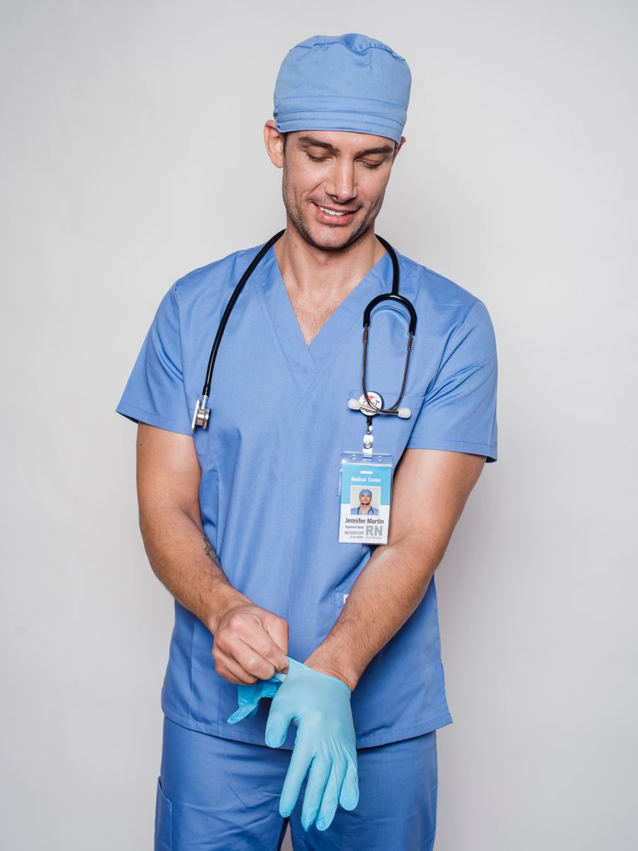 Male medical professional wearing sage scrubs