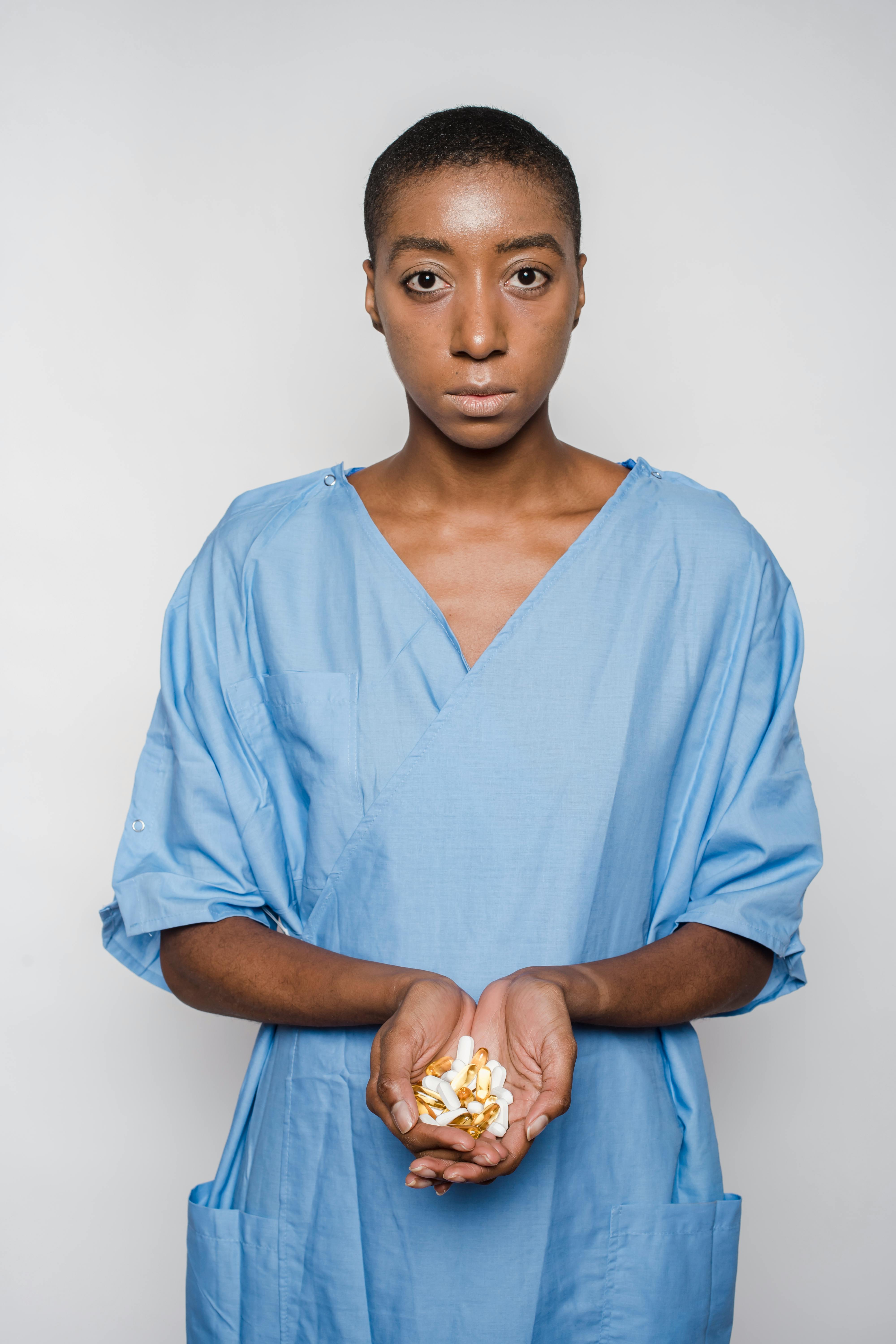 african american woman with handful of pills