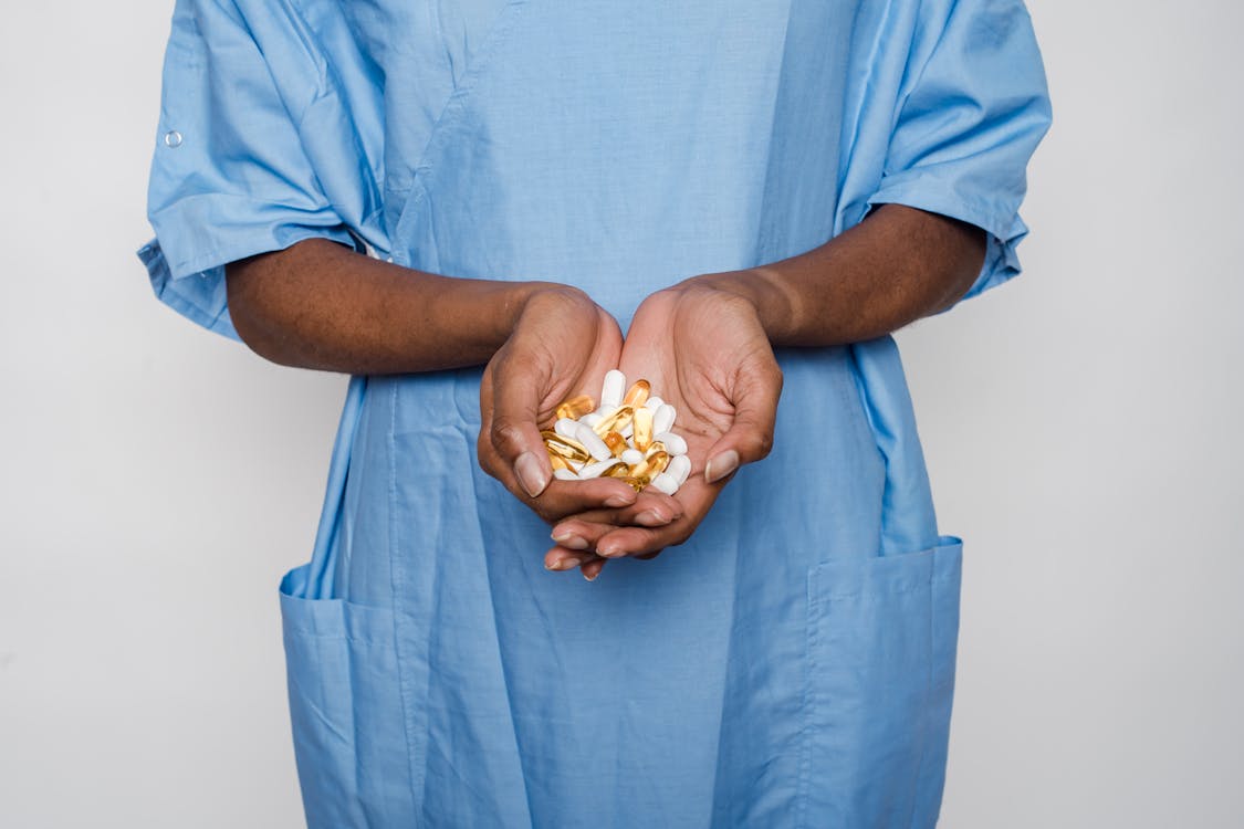 Free Unrecognizable black female patient with medical pills Stock Photo