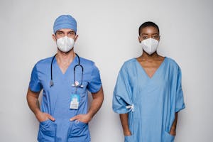 Multiracial doctor and patient in uniform and masks