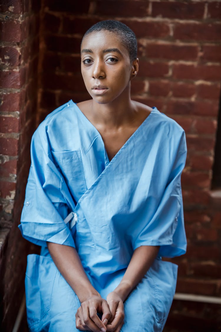 Pensive Black Patient Near Brick Wall