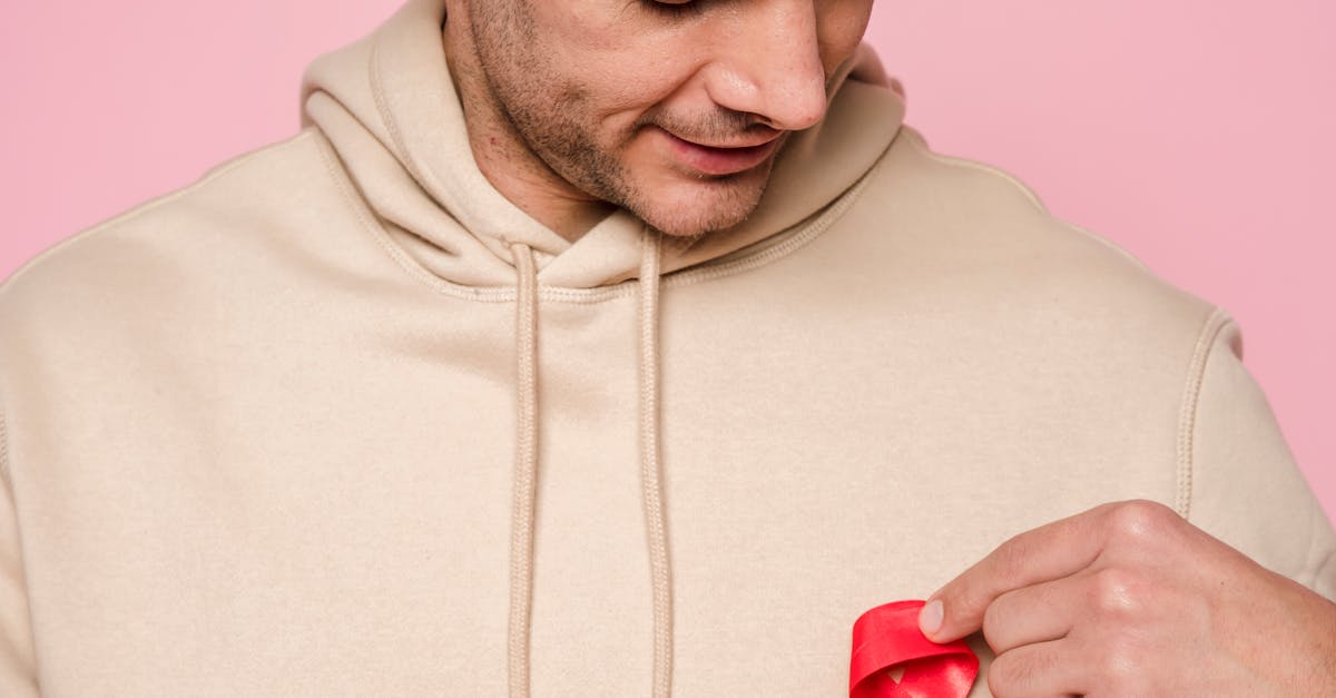 Man Putting A Red Ribbon · Free Stock Photo