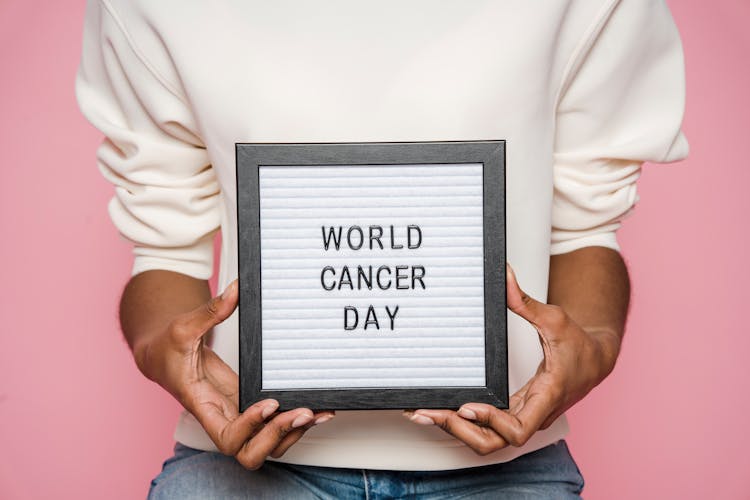 Black Person Showing Letterboard With World Cancer Day Inscription