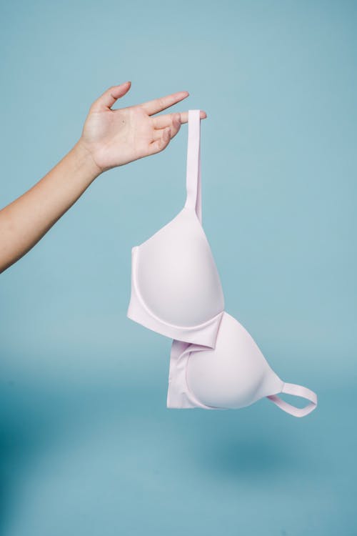 Woman showing bra against blue background
