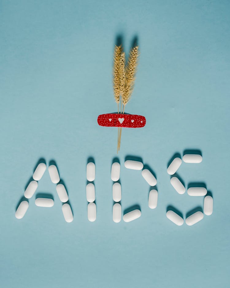 Pills In Form Of Inscription AIDS Placed On Table