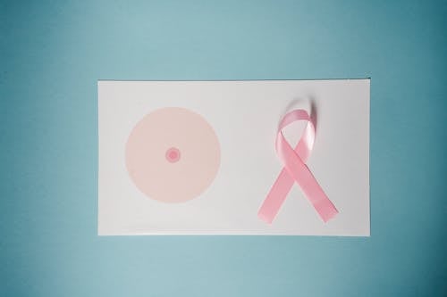 Pink Ribbon On Top Of A Paper