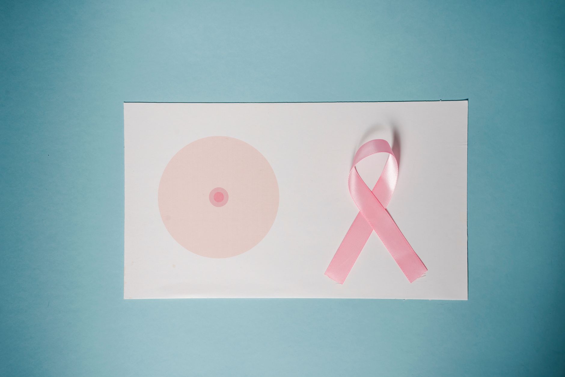 Concepto de concientización sobre el cáncer de mama con cinta rosa sobre fondo pastel.