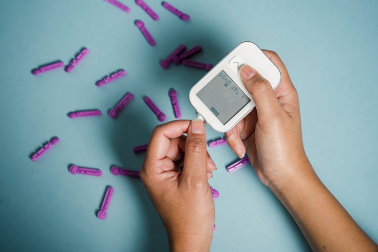 Woman Measuring Blood Sugar With Electronic Device