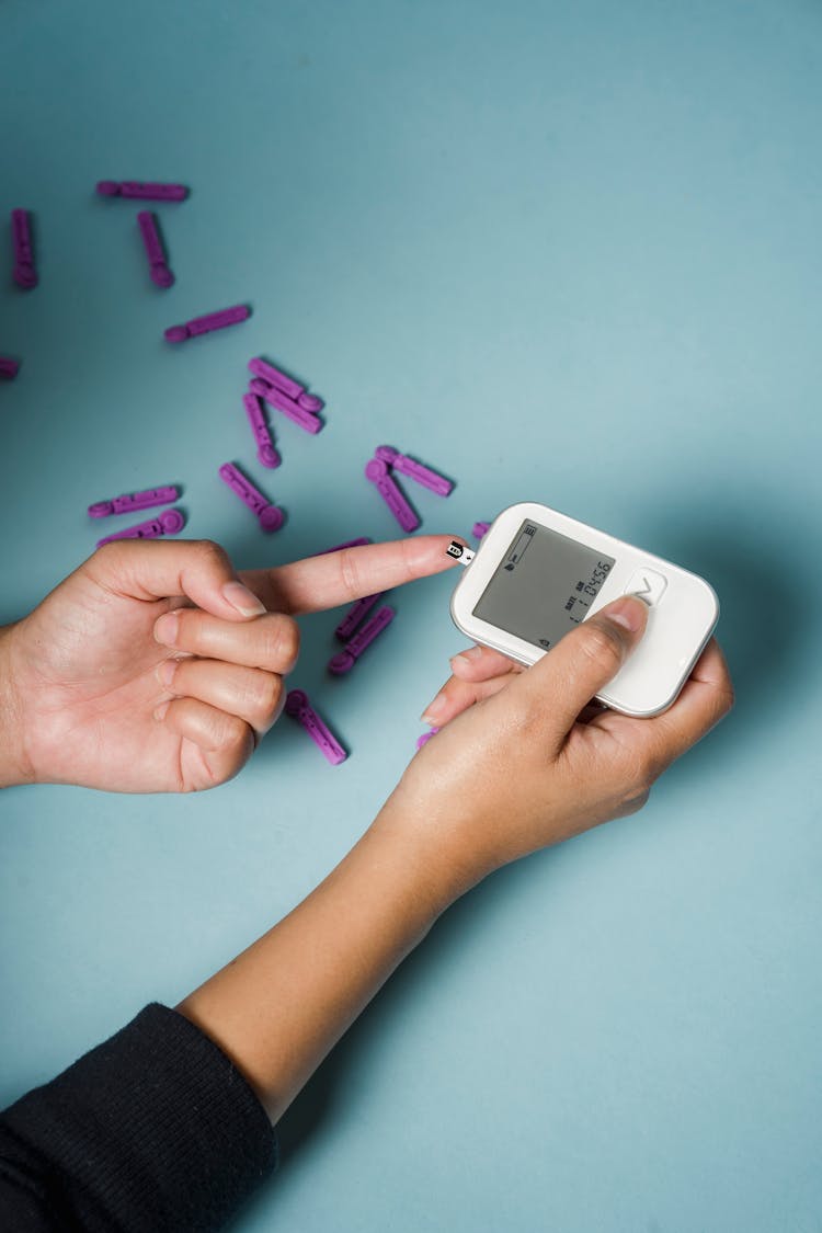 Woman Checking Blood Sugar With Glucometer