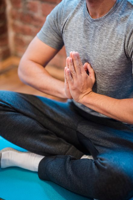 Man seated with hands together in meditation — photo by Klaus Nielsen on Pexels