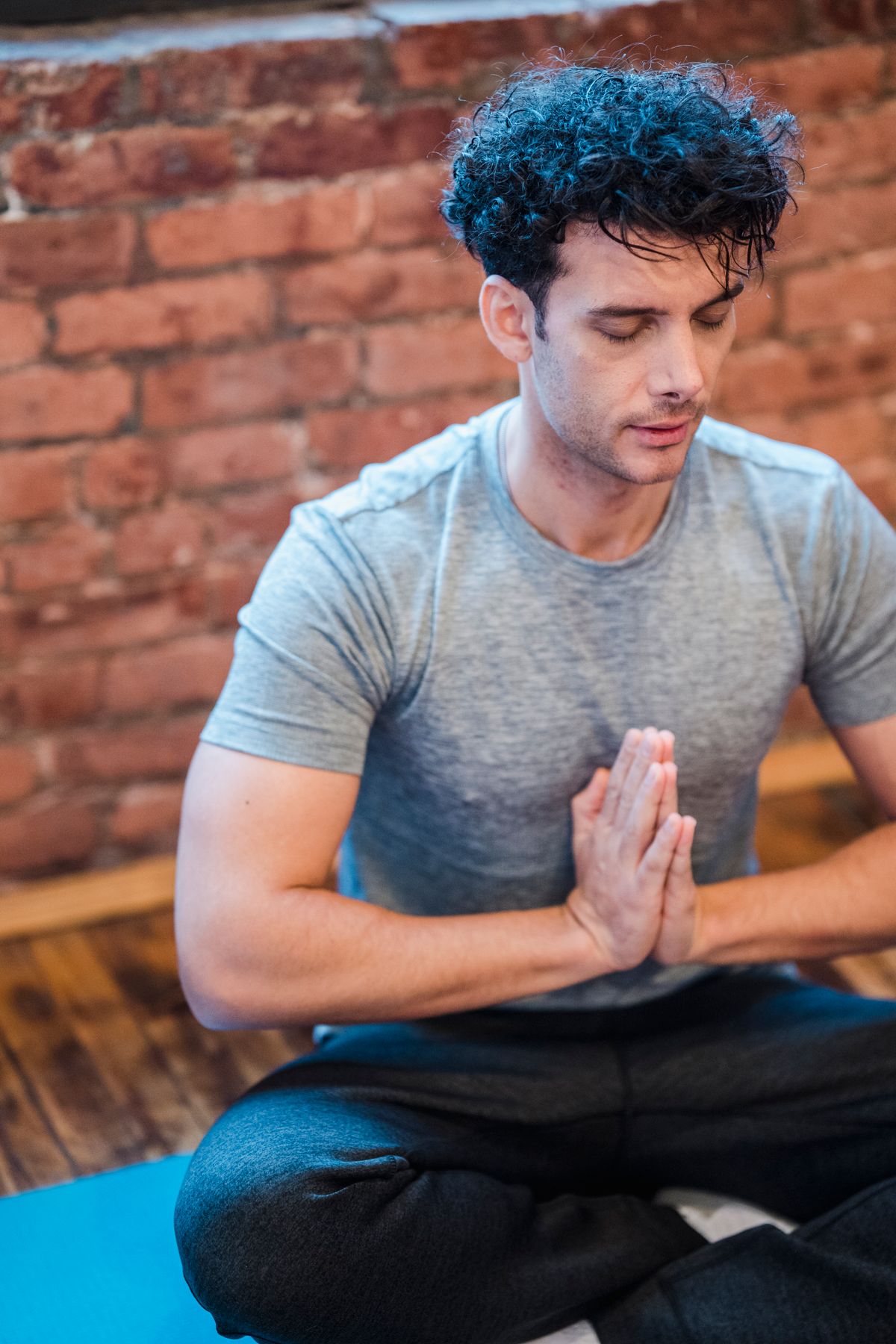 Person seated cross-legged practicing focused breathing and quiet posture