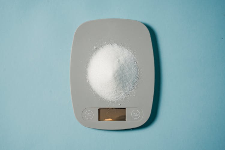 Electronic Scales With Heap Of Sugar