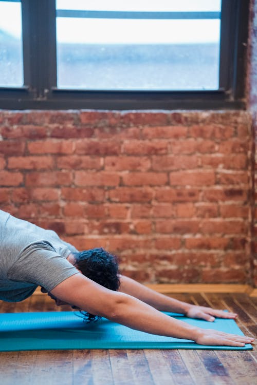 Man doing Extended Puppy yoga asana