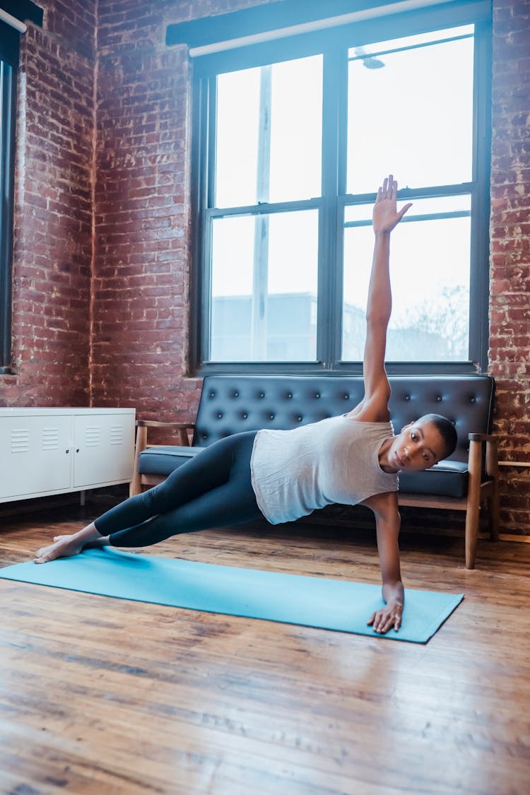 Black Woman Side Forearm Plank During Yoga Practice