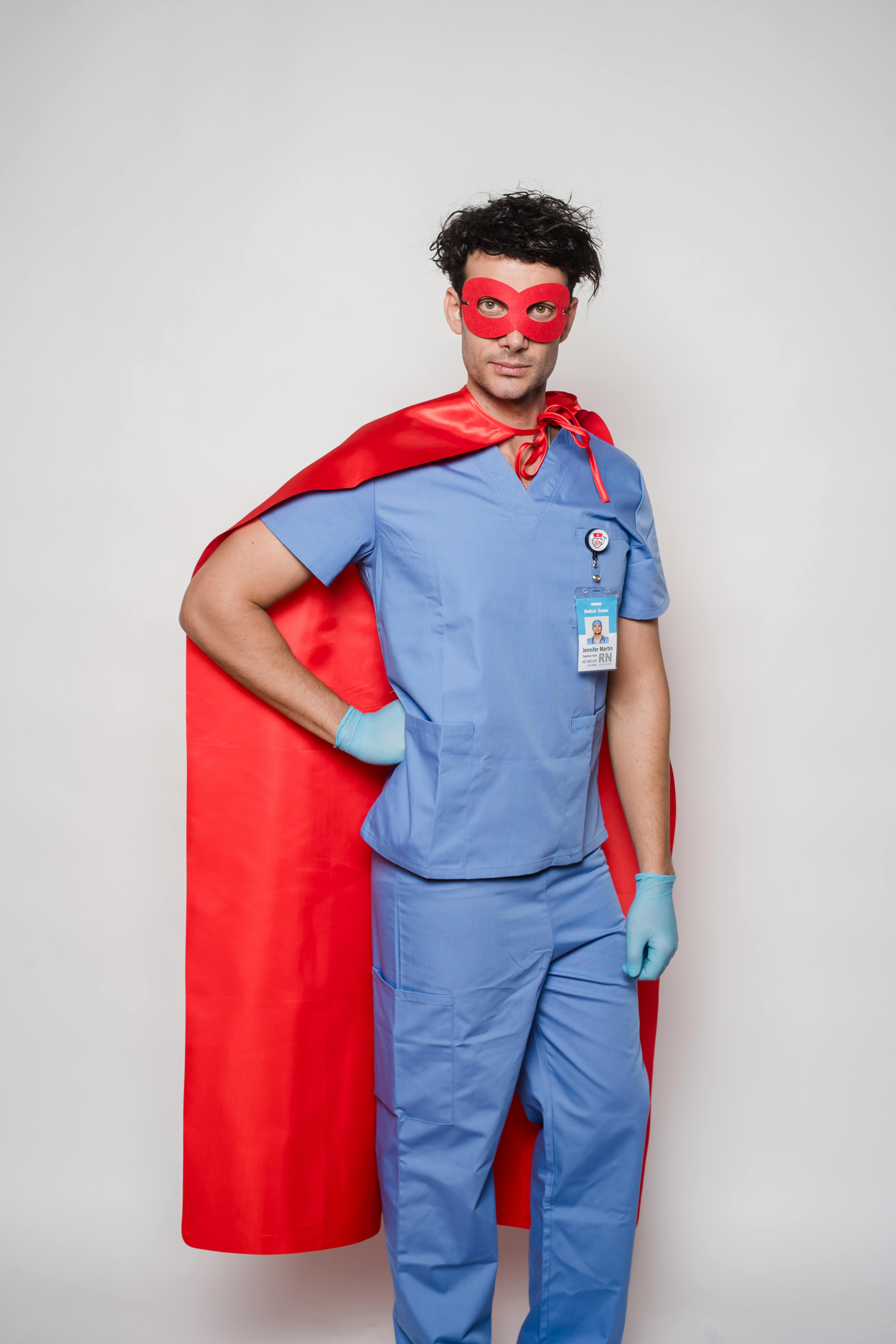 fearless male in medical uniform and superhero costume