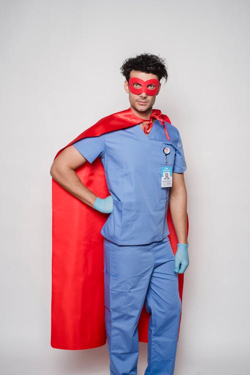 Free Fearless male in medical uniform and superhero costume Stock Photo
