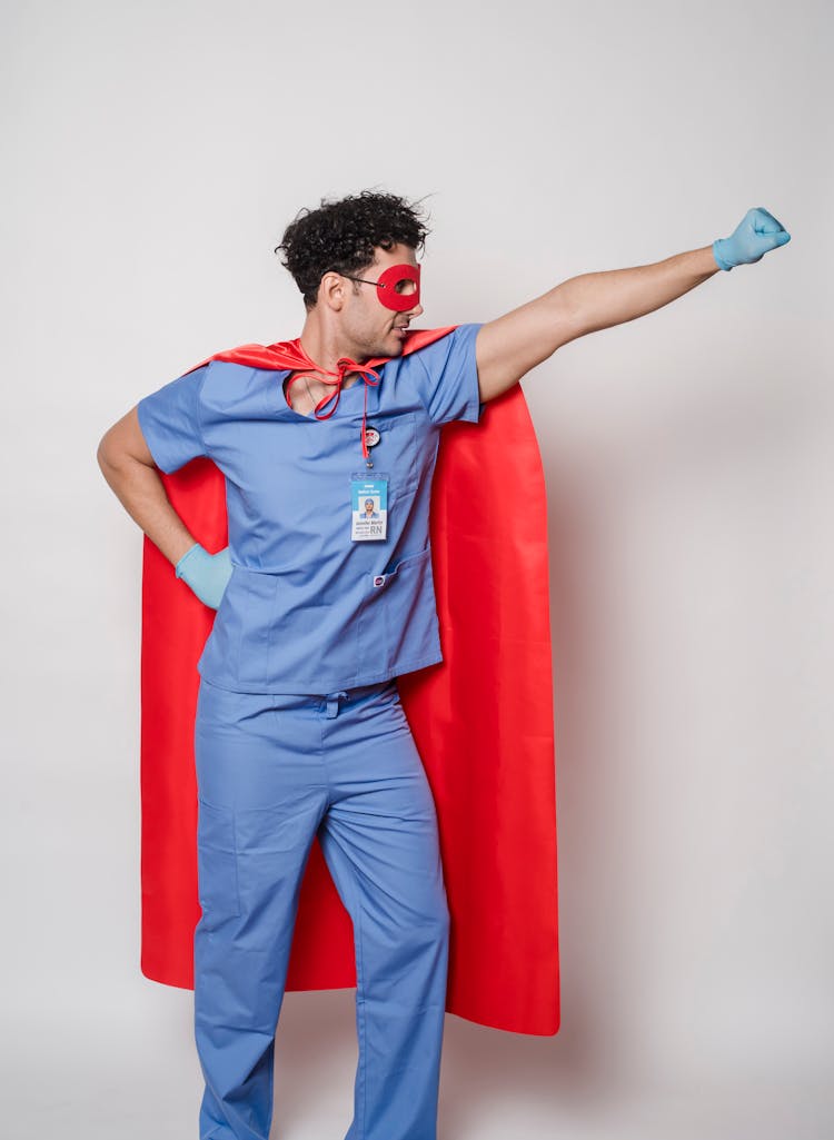 Male Doctor In Superhero Raising Fist For Protection Against COVID 19