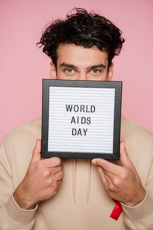 Man Holding A Frame With Words On it