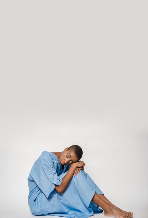 Black woman in blue patient gown