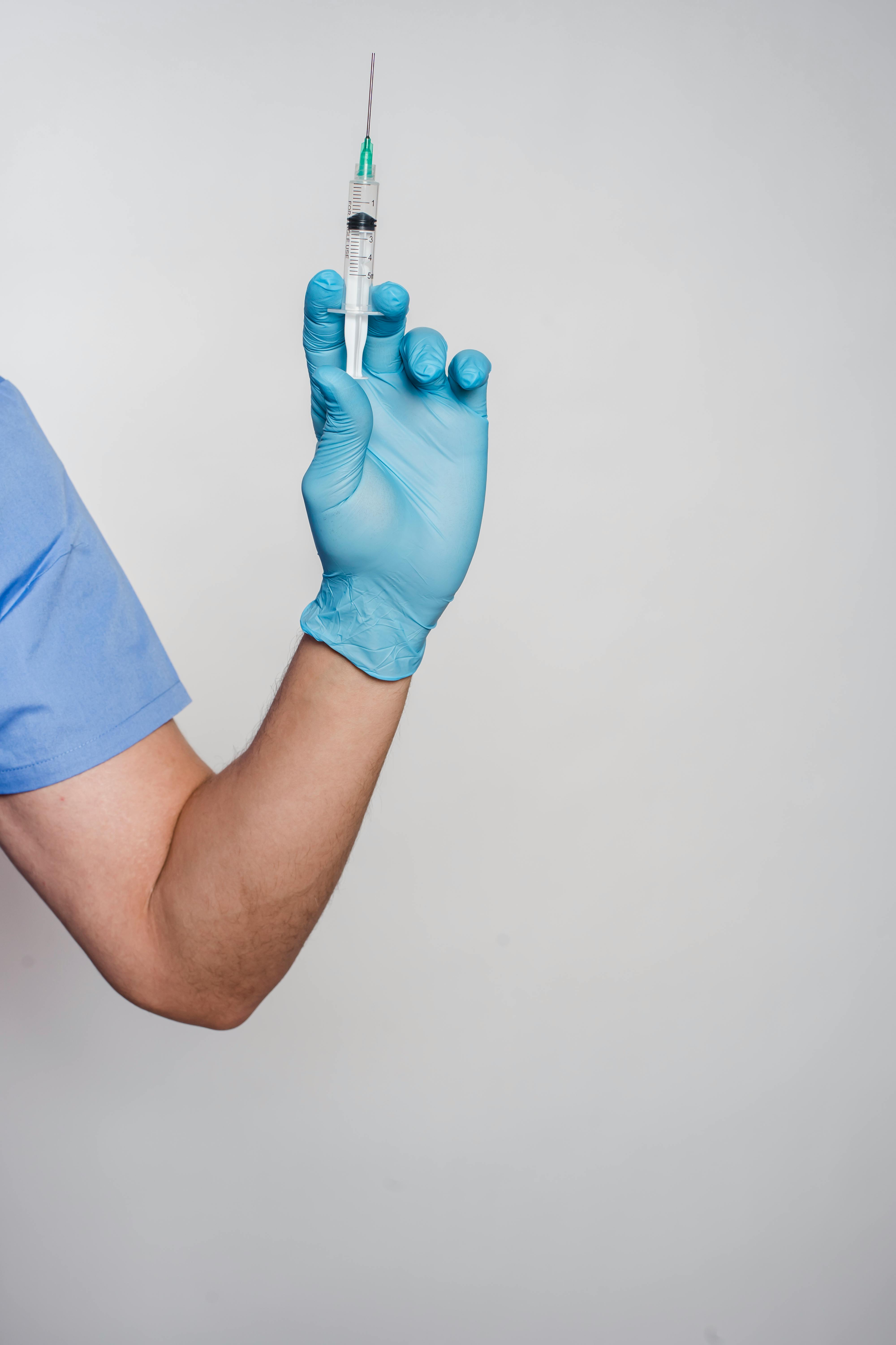 Man in latex sterile glove showing syringe \u00b7 Free Stock Photo