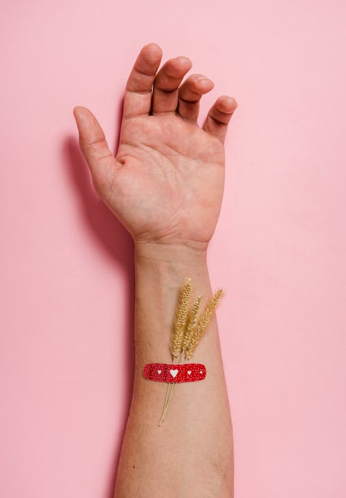 Free Person With Red Band Aid On The Wrist Stock Photo